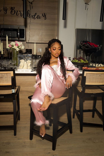 Woman in pink satin outfit holding flowers on a couch, Cloud Nine- Satin Pajamas Set- Pink, Relax in luxurious Mi Amore loungewear. Comfortable, stylish, and perfect for home or casual wear in Trinidad and Tobago.
Mi Amore House of Styles