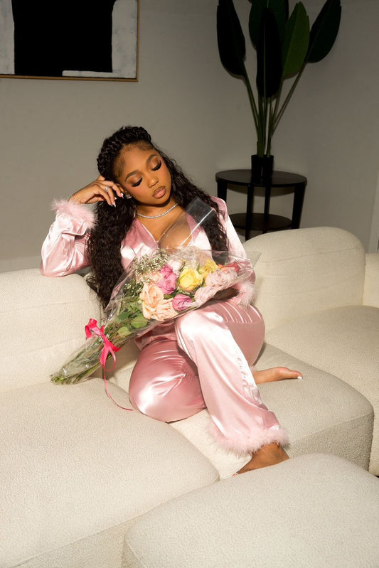 Woman in pink satin outfit holding flowers on a couch, Cloud Nine- Satin Pajamas Set- Pink, Relax in luxurious Mi Amore loungewear. Comfortable, stylish, and perfect for home or casual wear in Trinidad and Tobago.
Mi Amore House of Styles