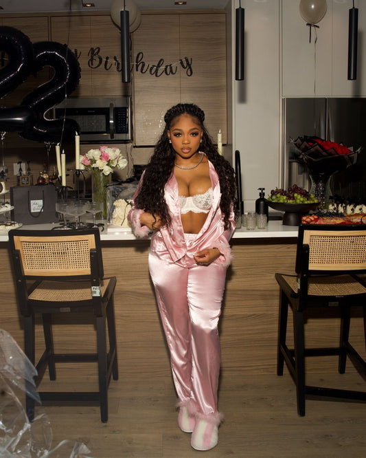 Woman in pink satin outfit holding flowers on a couch, Cloud Nine- Satin Pajamas Set- Pink, Relax in luxurious Mi Amore loungewear. Comfortable, stylish, and perfect for home or casual wear in Trinidad and Tobago.
Mi Amore House of Styles